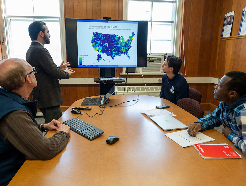 A photo of people looking at a virtual map