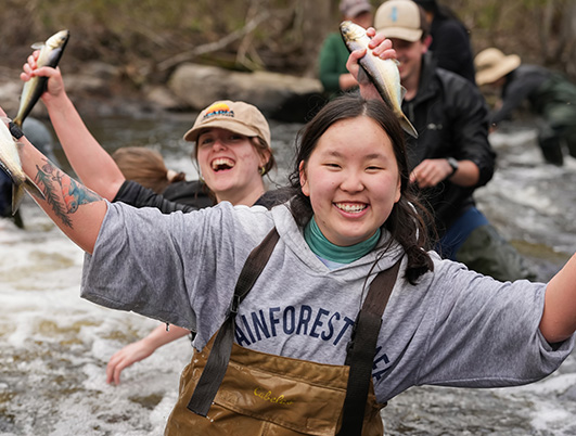 A photo of students holding fish