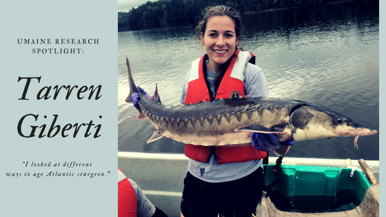 Tarren Giberti holds Atlantic sturgeon.