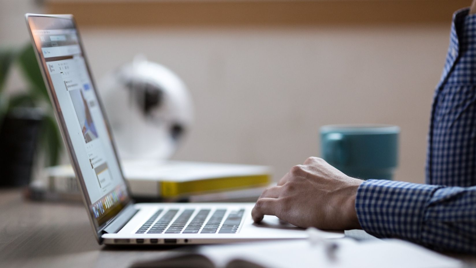 person at table with computer