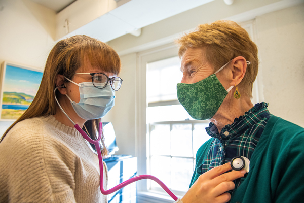 nursing student in practice room with patient