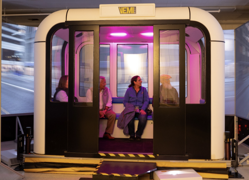 Photograph of visitors using VEMI Labs autonomous vehicle.