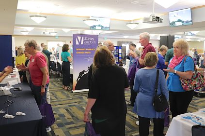 Attendees chat and look at displays at the 2023 Retiree Homecoming