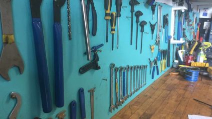 used tools hanging on a wall