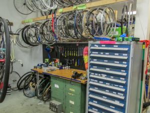 spare wheels and other parts at a bike repair shop