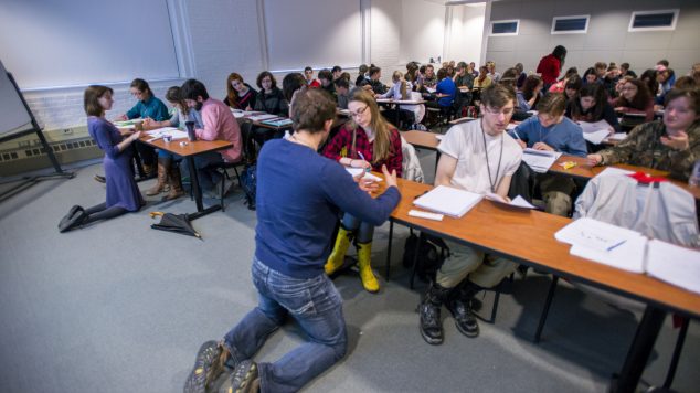 Instructor and MLAs helping students during a class activity