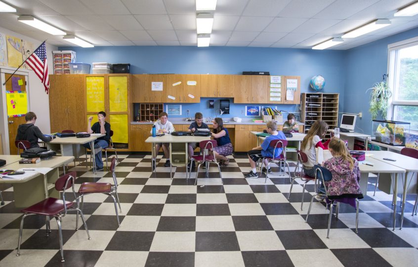 wide shot of a small middle school classroom with students