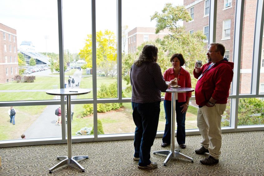 Group of teachers talking around a small table
