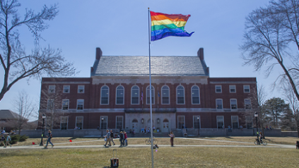Photo of Rainbow flag in front of Fogler Library