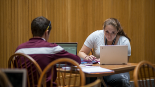 Color photo of two students studying