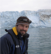 Dr. Seth Campbell in front of a glacier.