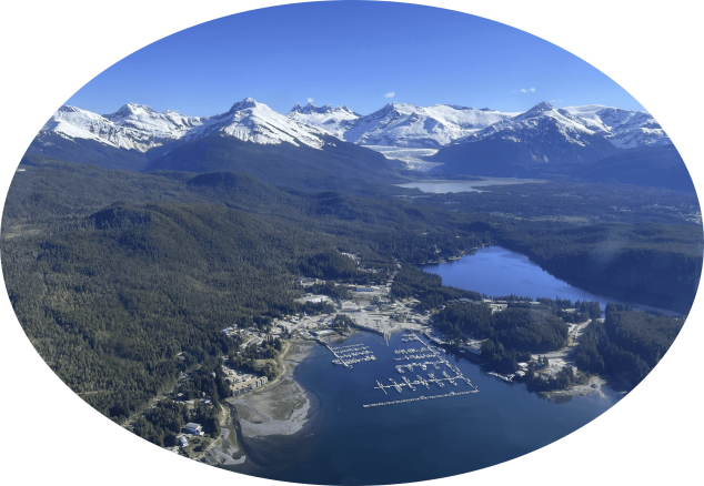 Aerial view of boat dock and mountains in the distance.