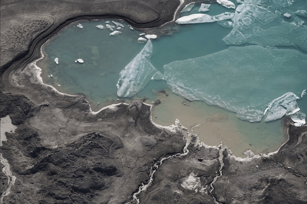 Arial view of blue lake on rocky shore