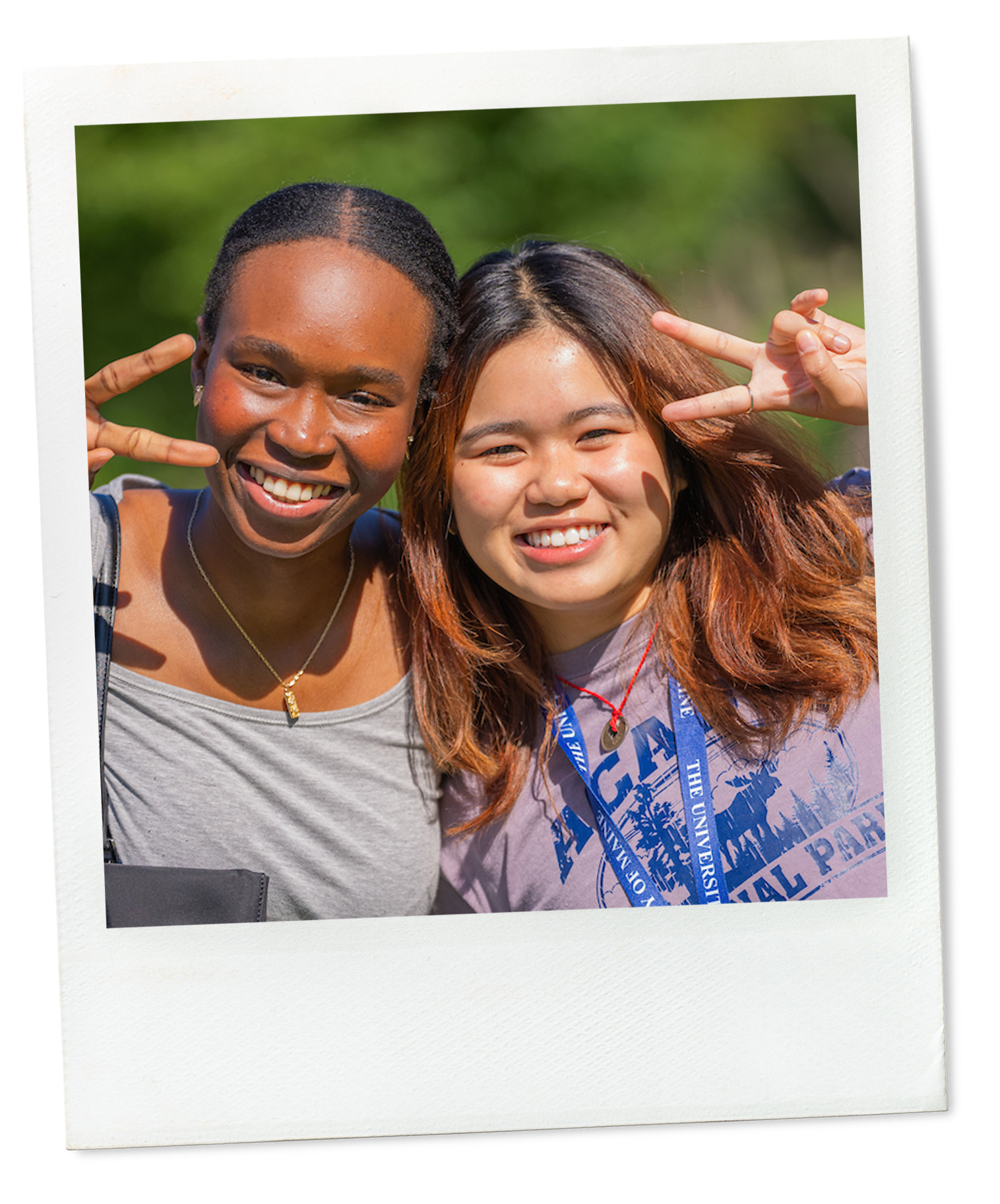 A polaroid of two students giving the peace sign