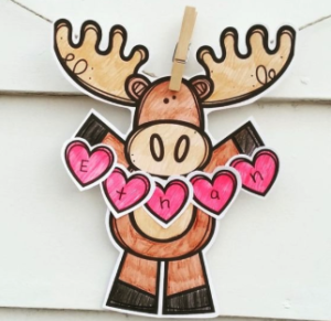 paper cutout of a moose holding a sign that says ethan