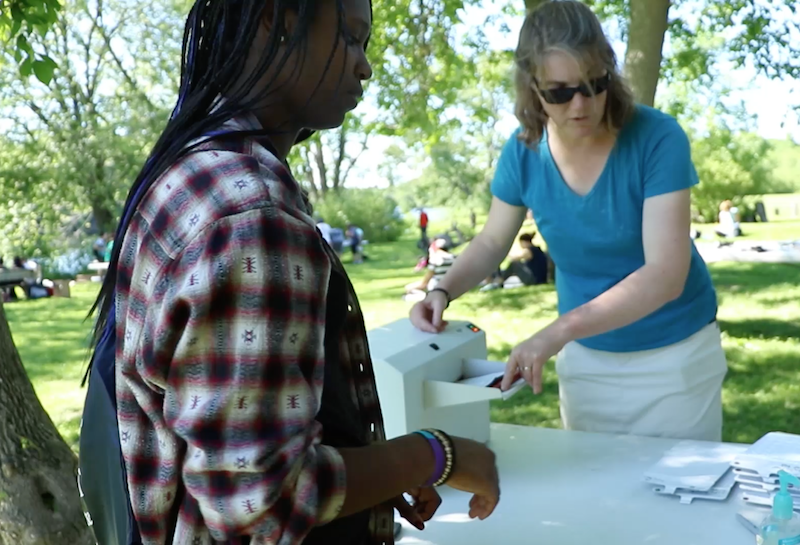 Teacher and student processing water sample outside at SMART Institute