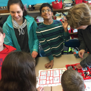 SMART Intern Annalyse works with STEM Club students on robotics project