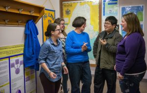 Students showing off research to Director of the School