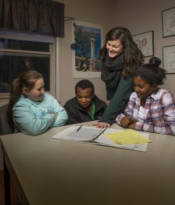 Student working with three young people