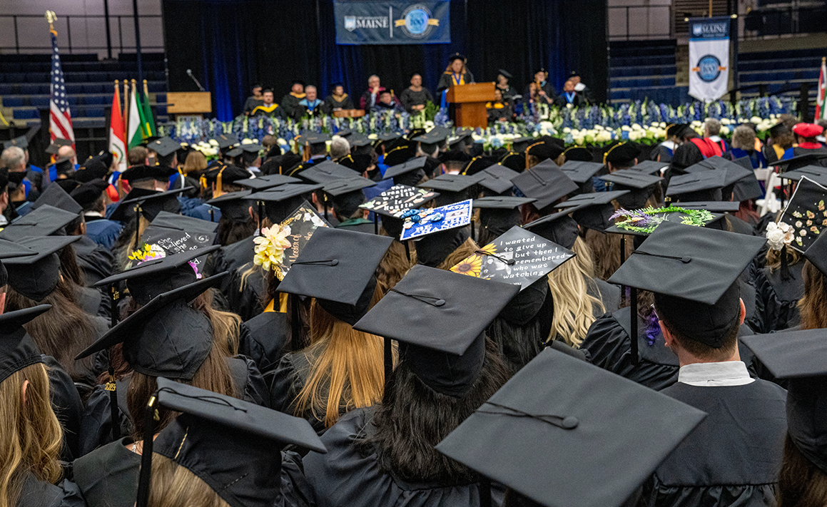 A photo of a group of graduate students at commencement 