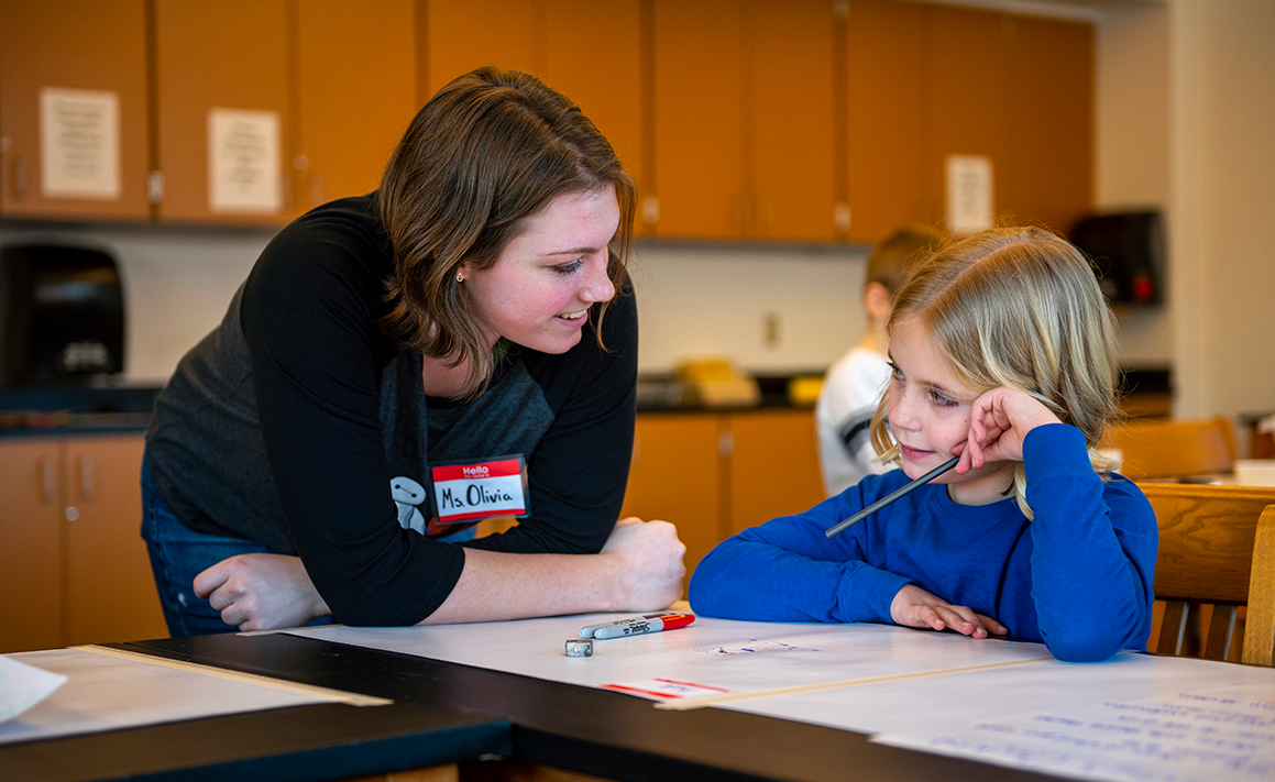 A photo of a social work student with a child