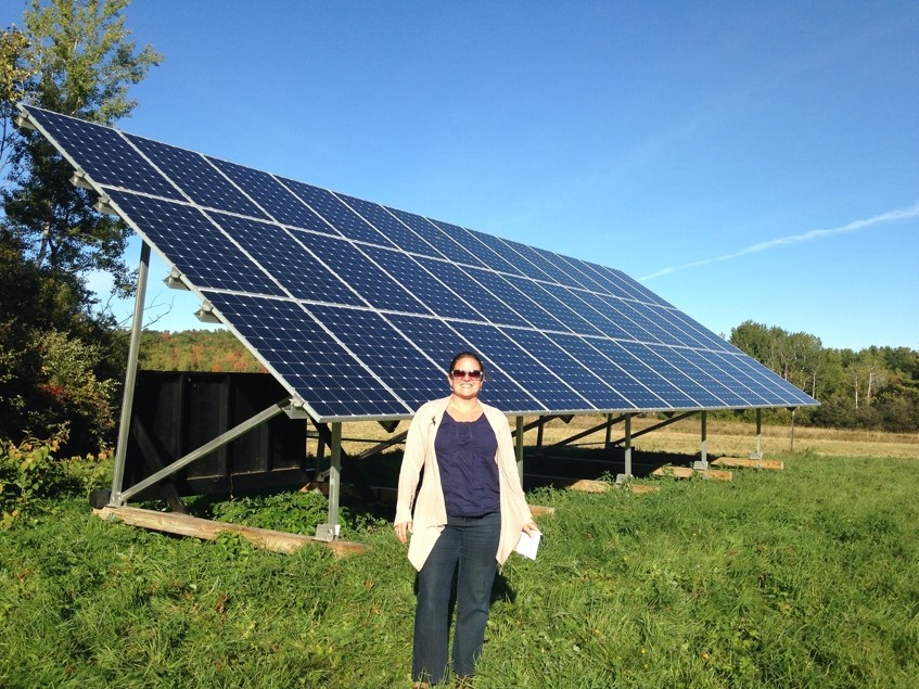 Dr. Sharon Klein standing by solar panel