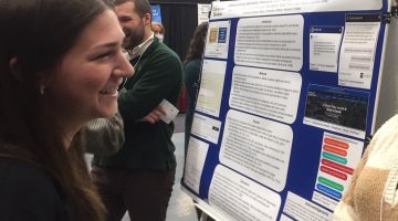 Photo of Student presenting poster at conference