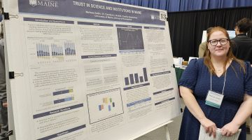 Photo of Student Presenting Poster at the Conference