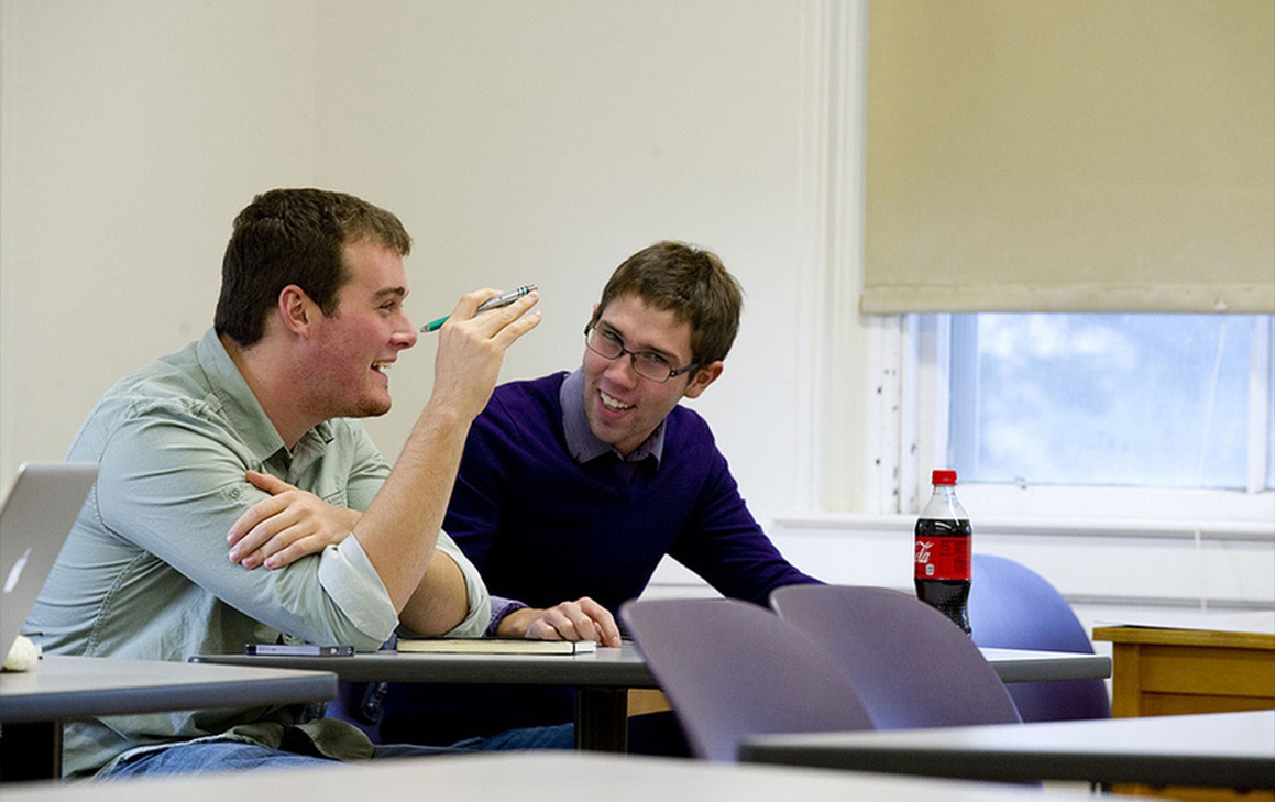 A photo of two students talking to each other