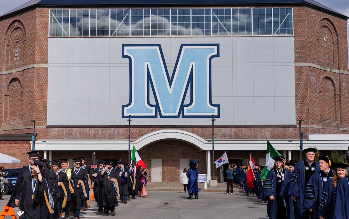 A photo of graduate students lining up for commencement