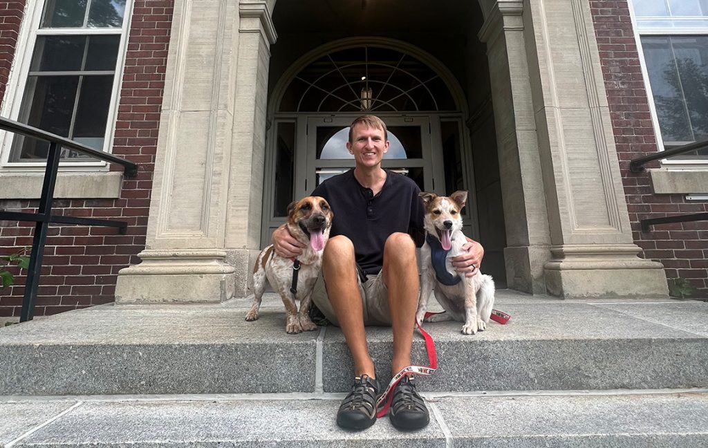 A photo of Travis Blackmer with two dogs