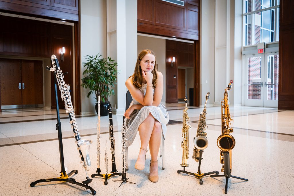 Megan Howell sits surrounded by various reed instruments.