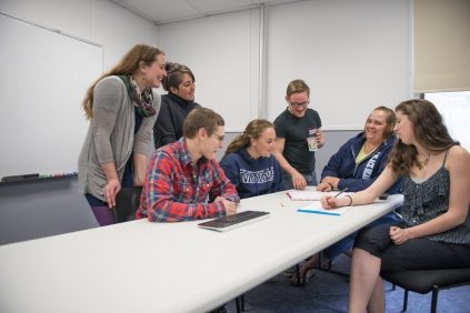 group of students looking at something on a piece of paper