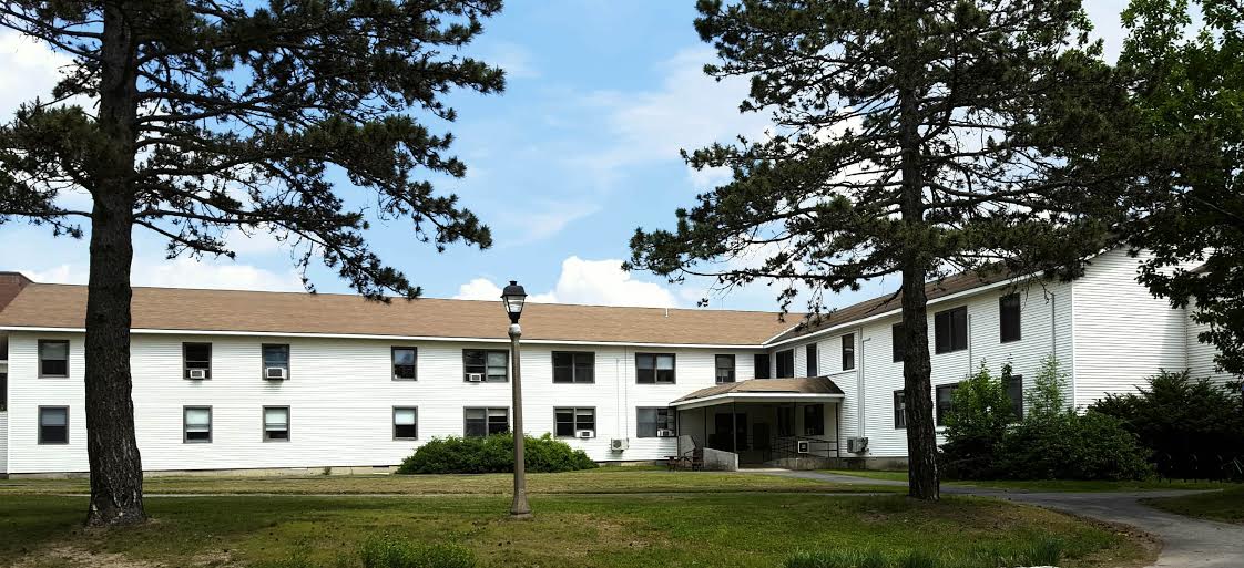 East Annex Building behind a few trees on the UMaine campus