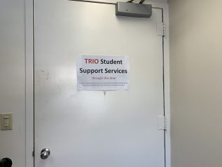 The TRIO SSS entrance with a sign that reads: "TRIO Student Support Services through this door".