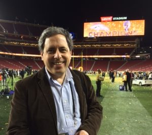 A headshot of Ken Belson standing on the Super Bowl 50 football field.