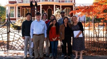 A group poses in front of Stephen King's Bangor home