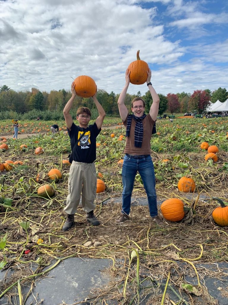 Exchange students picking pumpkins