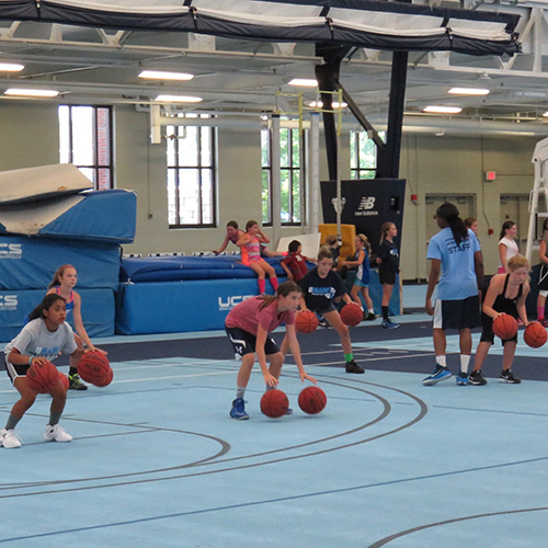 girls playing basketball at sports camp