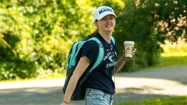 student walking and smiling