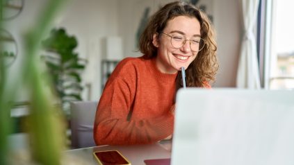 Person smiling while watching virtual event