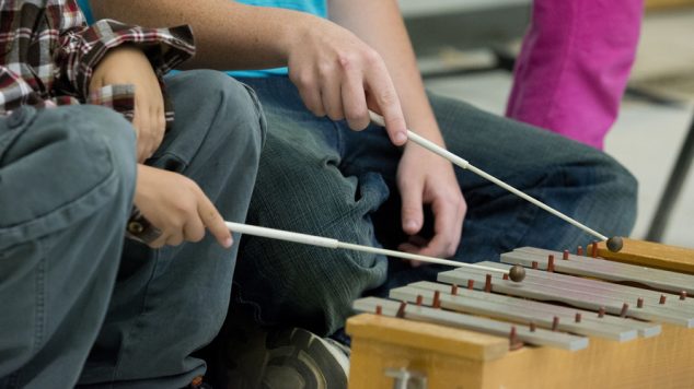 Two students playing the xylophone