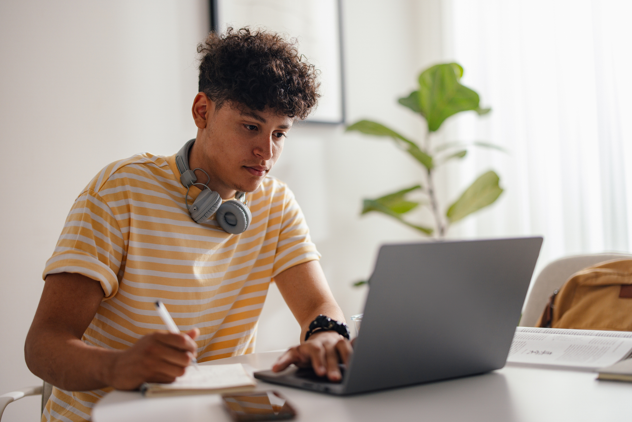 Teenage student studying with a laptop