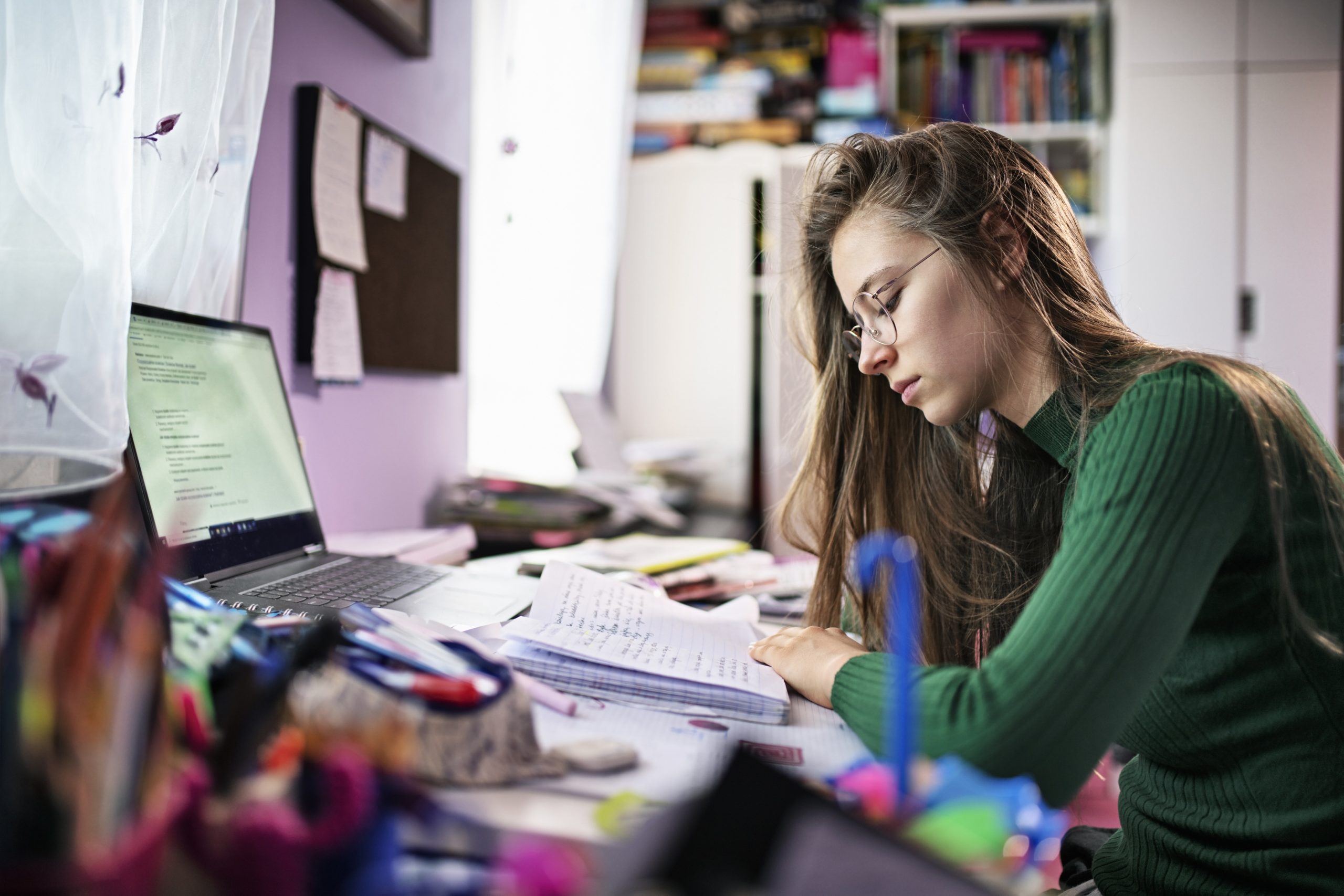 Teenager doing homework in their room.