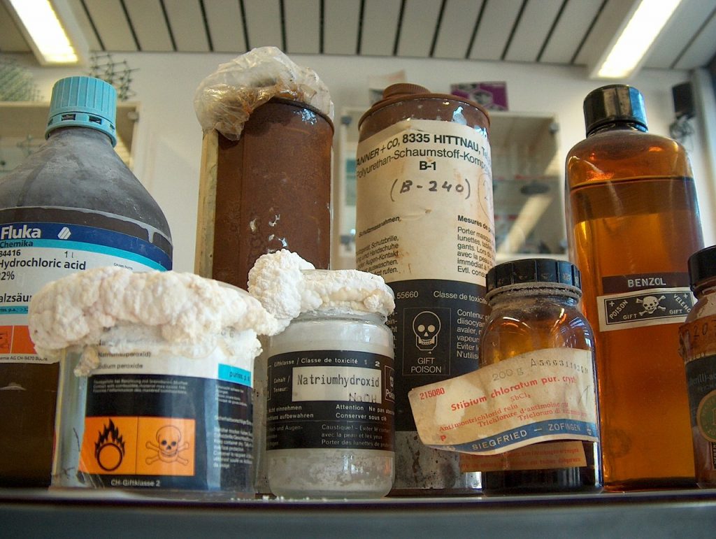 very old, hazardous chemicals sitting on a shelf.