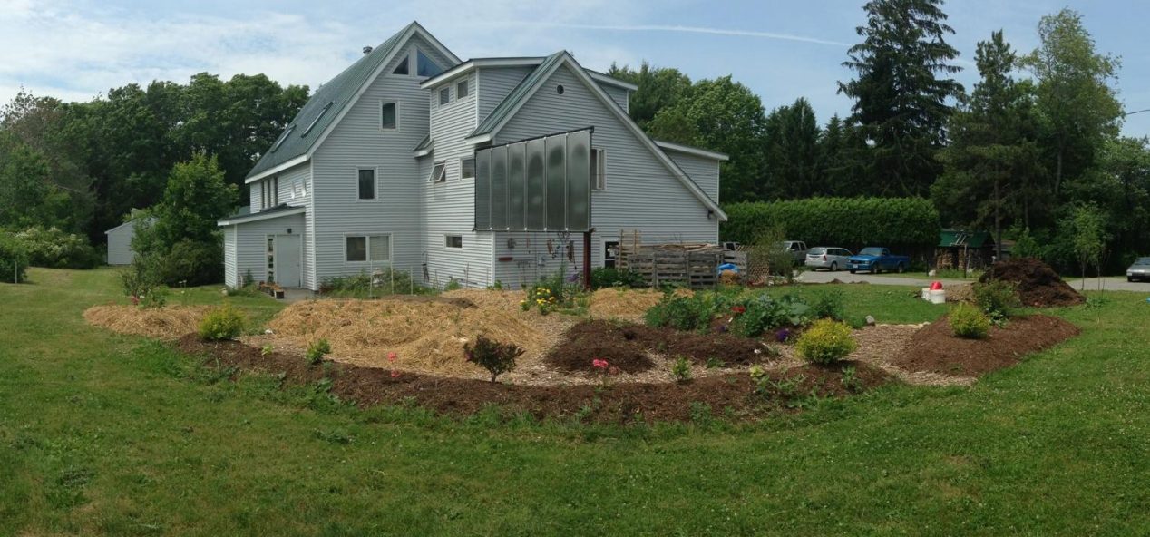 The outside of the Terrell House showing the garden and solar panels