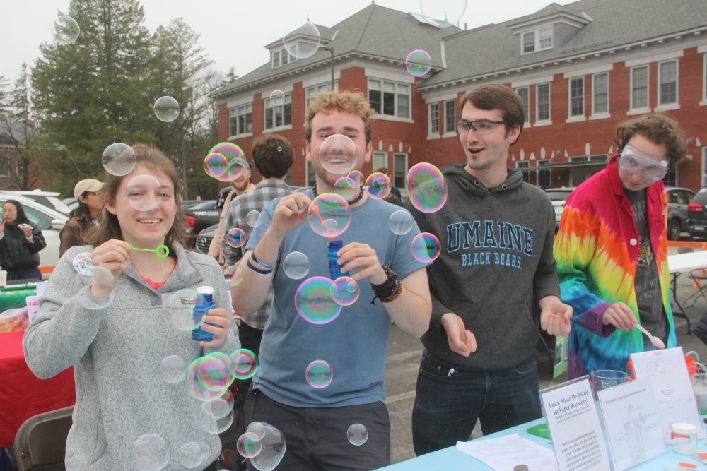 Students at Spring Fest blowing bubbles.