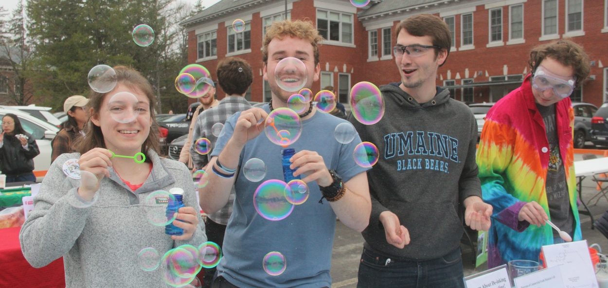 Students at Spring Fest blowing bubbles.