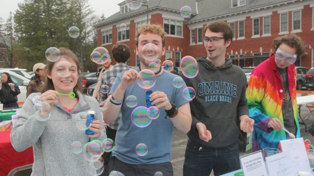 Students at Spring Fest blowing bubbles.