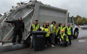 The zero-waste team in front of the recycling compactor truck